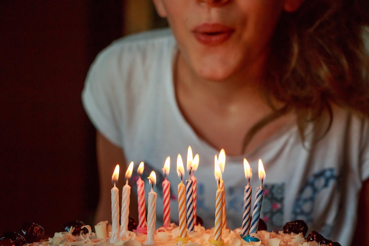 A child blows out the candles on a birthday cake